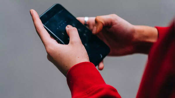Holding phone with both hands and using both thumbs