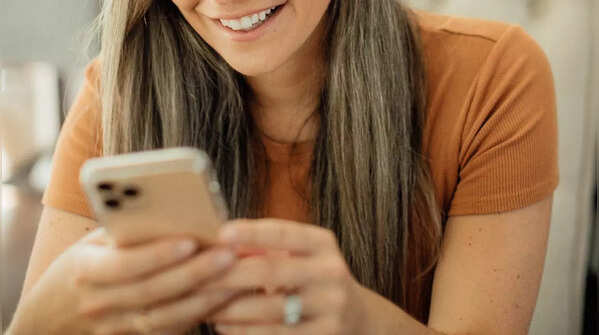 Holding phone with two hands and scrolling with one thumb